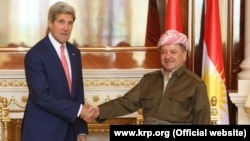 Kurdish leader Masud Barzani (right) meets with U.S. Secretary of State John Kerry in Irbil on June 24.